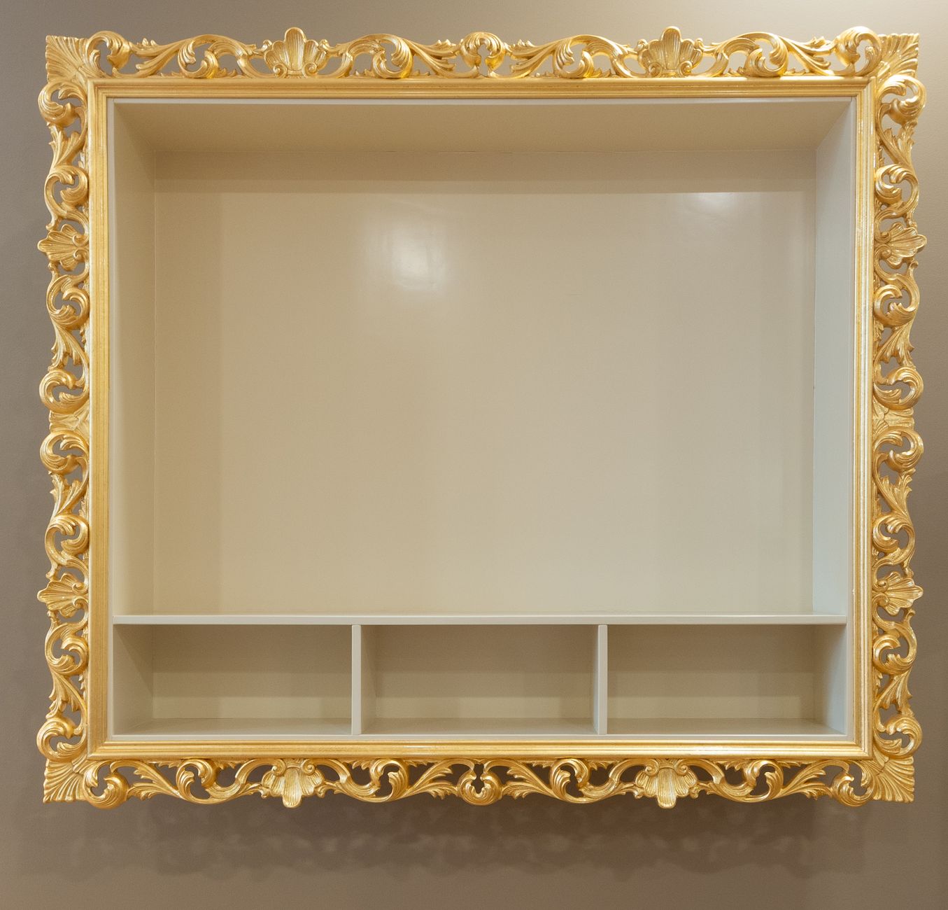 Elegant gold ornate frame shelf with multiple compartments for home decor.